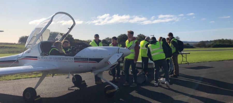 Eco-Dimona surrounded by students during a site visit to Fife airport